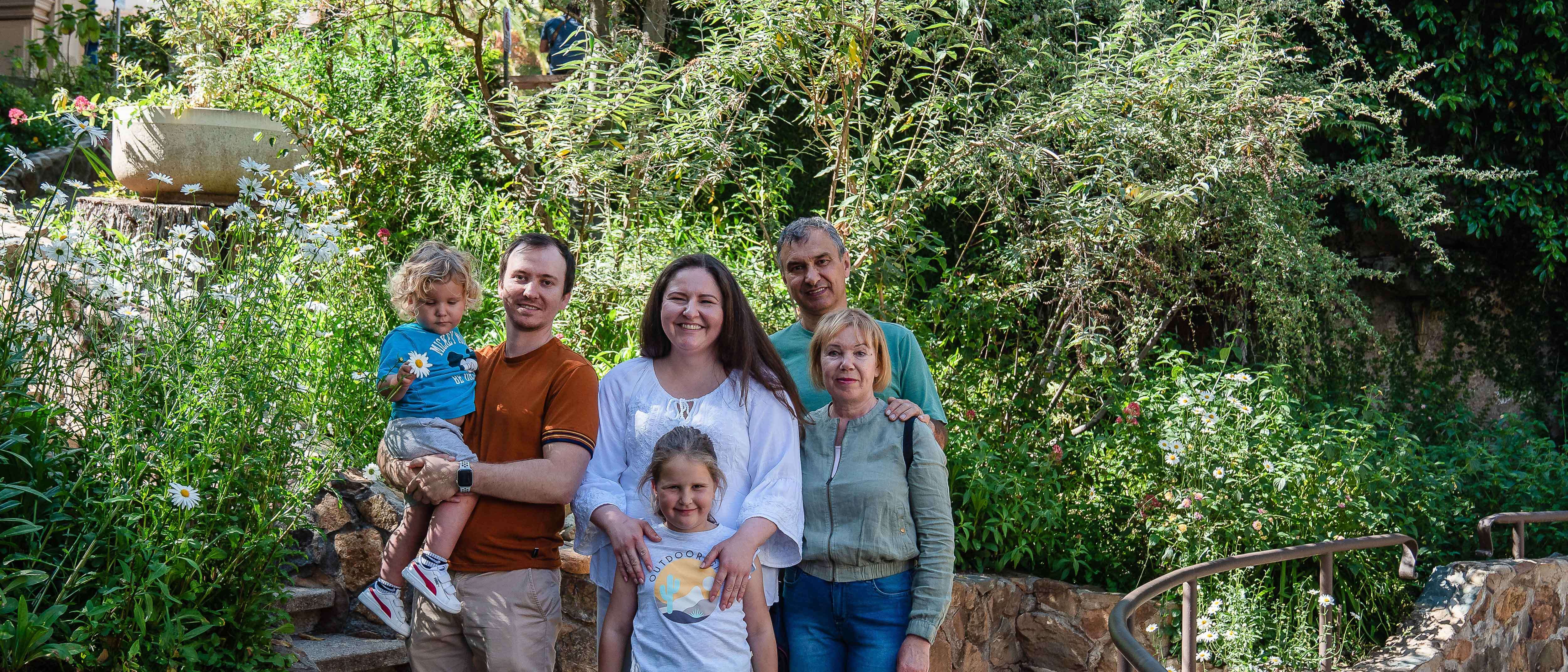 A Ukrainian refugee family poses for a photo outside in San Diego.